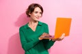 Portrait of satisfied gorgeous woman with short hair wear stylish clothes look at laptop chatting isolated on pink color