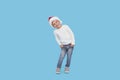 Portrait of a satisfied little child boy dressed in christmas Santa hat. laughing isolated over blue Royalty Free Stock Photo