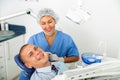 Portrait of satisfied man visiting dentist giving thumbs up in the dental clinic Royalty Free Stock Photo