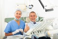 Portrait of satisfied man visiting dentist giving thumbs up in the dental clinic Royalty Free Stock Photo