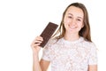 Portrait of a satisfied pretty girl biting eating chocolate bar in white copy space