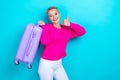 Portrait of satisfied pretty girl wear knit pullover hold valise showing okey going on vacation isolated on turquoise Royalty Free Stock Photo