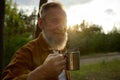 Portrait of satisfied retired man drinking hot steaming coffee or tea Royalty Free Stock Photo