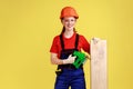 Satisfied smiling carpenter woman working with fretsaw, holding wooden panel. Royalty Free Stock Photo