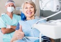 Portrait of satisfied woman visiting dentist giving thumbs up Royalty Free Stock Photo