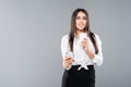 Portrait of satisfied young business woman using mobile phone while holding cup of coffee to go isolated over white background Royalty Free Stock Photo
