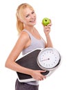 Portrait, scale and happy woman with apple for diet, benefits or food to lose weight in studio. Healthy eating Royalty Free Stock Photo