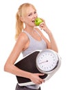 Portrait, scale and woman with apple for progress, diet benefits or food to lose weight in studio. Healthy eating Royalty Free Stock Photo