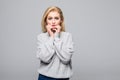 Portrait of scared amazed young woman looks with terrified expression at camera, biting her nails as being nervous, isolated Royalty Free Stock Photo