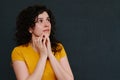 Portrait of scared emotional girl on grey background. Upset.