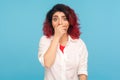 Portrait of scared hipster woman with fancy red hair covering mouth with hand and looking frightened at camera Royalty Free Stock Photo