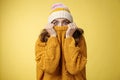 Portrait scared insecure timid cute girl hiding face pull sweater nose widen eyes afraid stunned standing stupor yellow