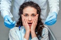 Portrait of a scared woman during dental examination