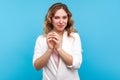 Portrait of scheming sly woman smirking and pondering cunning devious plan on how to get what she wants. blue background