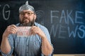 portrait of a schizophrenic conspiracy theorist in a foil hat with the inscription total control on the map. School Royalty Free Stock Photo