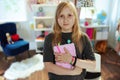 Portrait of school girl in grey shirt at home in sunny day Royalty Free Stock Photo