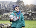 Portrait of School kid taking teddy bear explore with his learning history, Happy child boy wearing warm cloths holding his soft