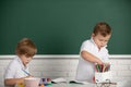 Portrait school kids bosy doing art homework, holding pencil, writing. Children pupils drawing on elementary school Royalty Free Stock Photo