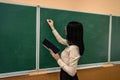 portrait of school teacher wear white blouse and glasses near on the background of the blackboard Royalty Free Stock Photo