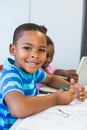 Portrait of schoolboy doing homework in classroom Royalty Free Stock Photo