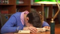 Portrait of schoolboy doing their homework and sleeping on the book. Royalty Free Stock Photo