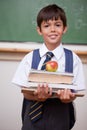 Portrait of a schoolboy holding books and an apple Royalty Free Stock Photo