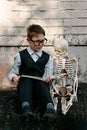 Portrait of a schoolboy hugging a skeleton. The concept of studying the structure of the body.