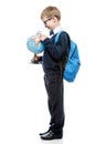 Portrait of a schoolboy with magnifier and globe on a white Royalty Free Stock Photo