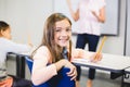 Portrait of schoolgirl smiling in classroom