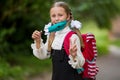 Portrait of a schoolgirl in a surgical mask. Concept of coronavirus COVID-19. Schoolgirl wearing medical face mask to health Royalty Free Stock Photo