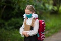 Portrait of a schoolgirl in a surgical mask. Concept of coronavirus COVID-19. Schoolgirl wearing medical face mask to health Royalty Free Stock Photo