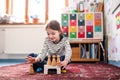 Portrait of schoolgirl using educational tool, learning while playing. Student girl in classroom at the elementary Royalty Free Stock Photo