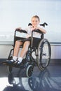 Portrait of schoolkid sitting on wheelchair