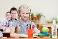 Portrait of schoolkids looking at camera at workplace