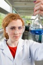 Portrait of a science student holding a flask Royalty Free Stock Photo