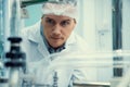 Portrait of a scientist, apothecary extracting cannabis oil in laboratory.