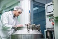 Portrait of a scientist, apothecary extracting cannabis oil in laboratory.