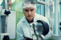 Portrait of a scientist, apothecary extracting cannabis oil in laboratory.