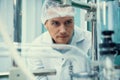 Portrait of a scientist, apothecary extracting cannabis oil in laboratory.