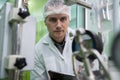 Portrait of a scientist, apothecary extracting cannabis oil in laboratory.