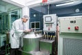 Portrait of a scientist, apothecary extracting cannabis oil in laboratory.