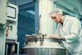 Portrait of a scientist, apothecary extracting cannabis oil in laboratory.