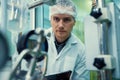 Portrait of a scientist, apothecary extracting cannabis oil in laboratory.