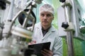 Portrait of a scientist, apothecary extracting cannabis oil in laboratory.