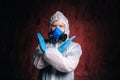 Portrait of scientist virologist wearing protective suit, glasses and respirator