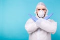 Portrait of scientist virologist wearing protective suit, glasses and respirator showing STOP gesture with two crossed