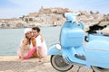 Portrait of scooter and cheerful couple relaxing by the sea Royalty Free Stock Photo