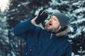 Portrait of screaming bearded man traveler forester hunter in winter forest