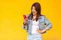 Portrait of screaming beautiful brunette young woman with makeup in denim casual style standing, shocked and looking at her red Royalty Free Stock Photo