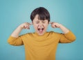 portrait of a Screaming little boy covering ears with hands Royalty Free Stock Photo